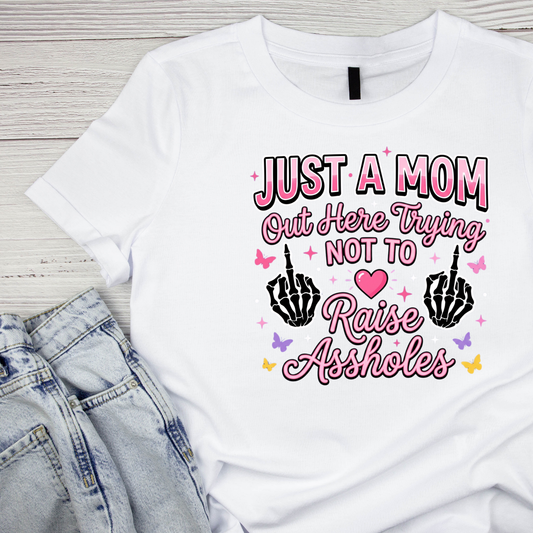 Just A Mom Out Here Trying Not To Raise Assholes Skeleton Hand T-shirt | Mama Graphic Tee | Mommy Printed Shirt | Mother’s Day | Birthday |